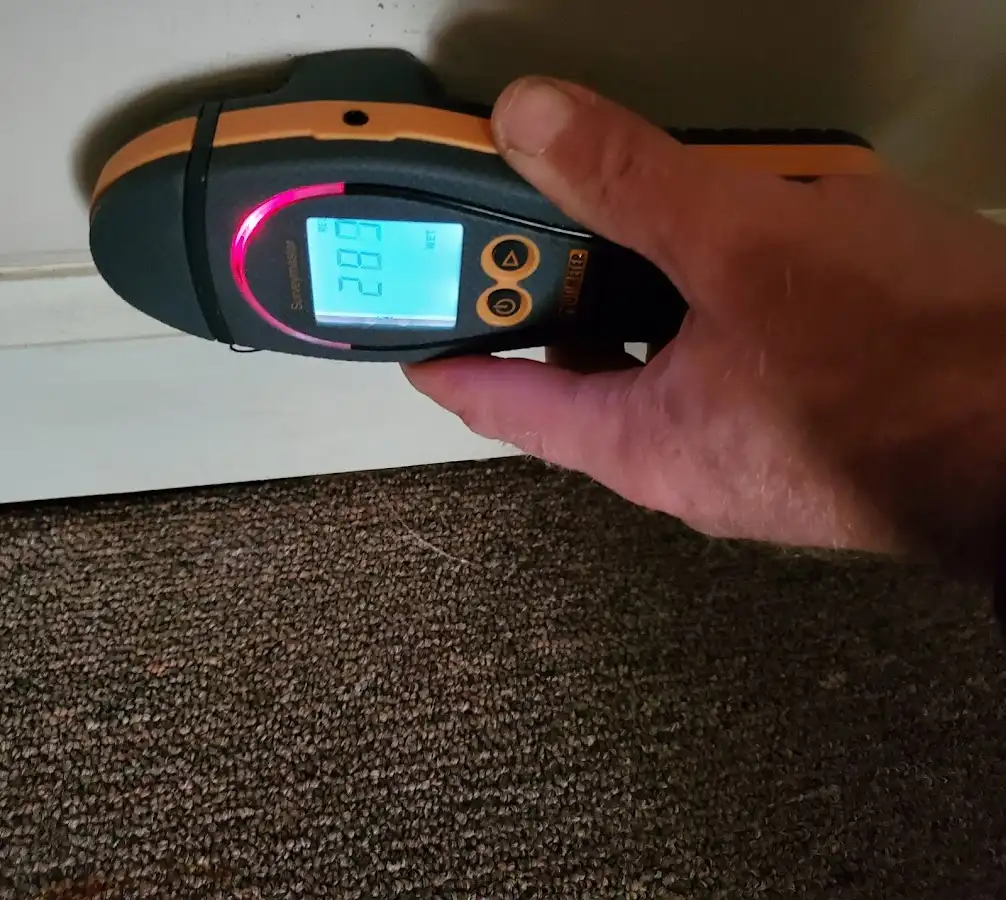 Moisture detection at baseboard during Storm Damage Restoration in Rolesville